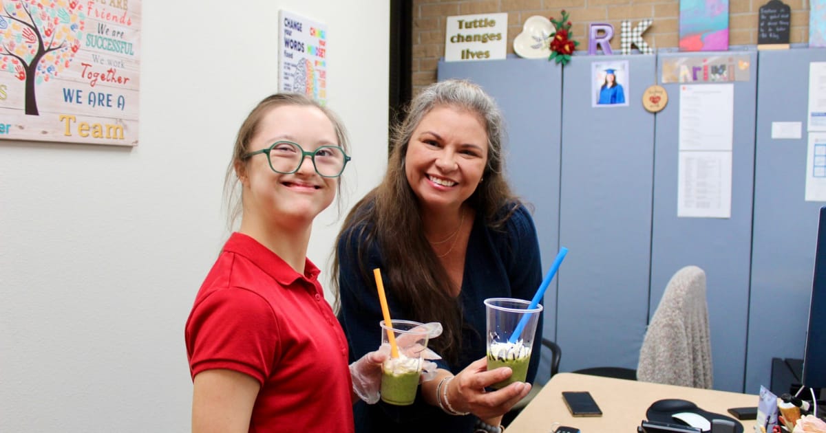 Tuttle student delivers two smoothies to a staff member.