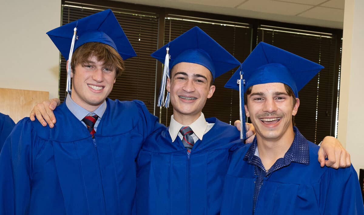 Three briarwood graduates stand and smile.